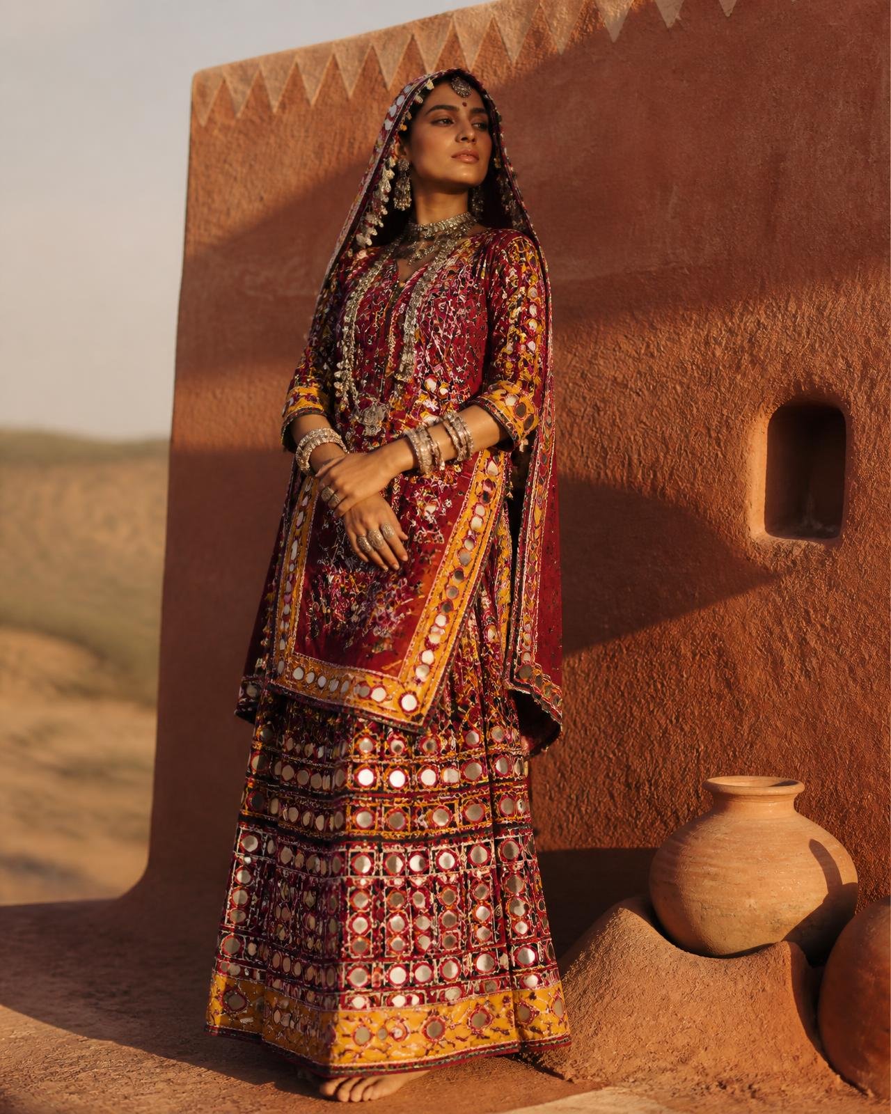 A woman wearing a handcrafted Banjara dress with mirror work and vivid embroidery